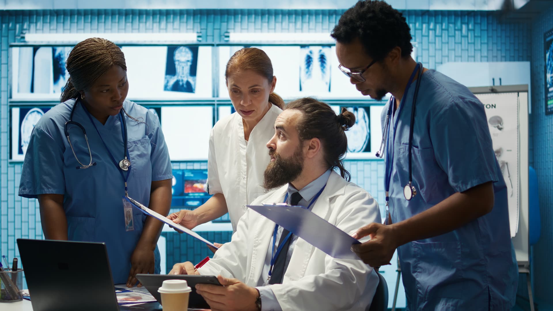 Clinical team reviewing patient records on a tablet