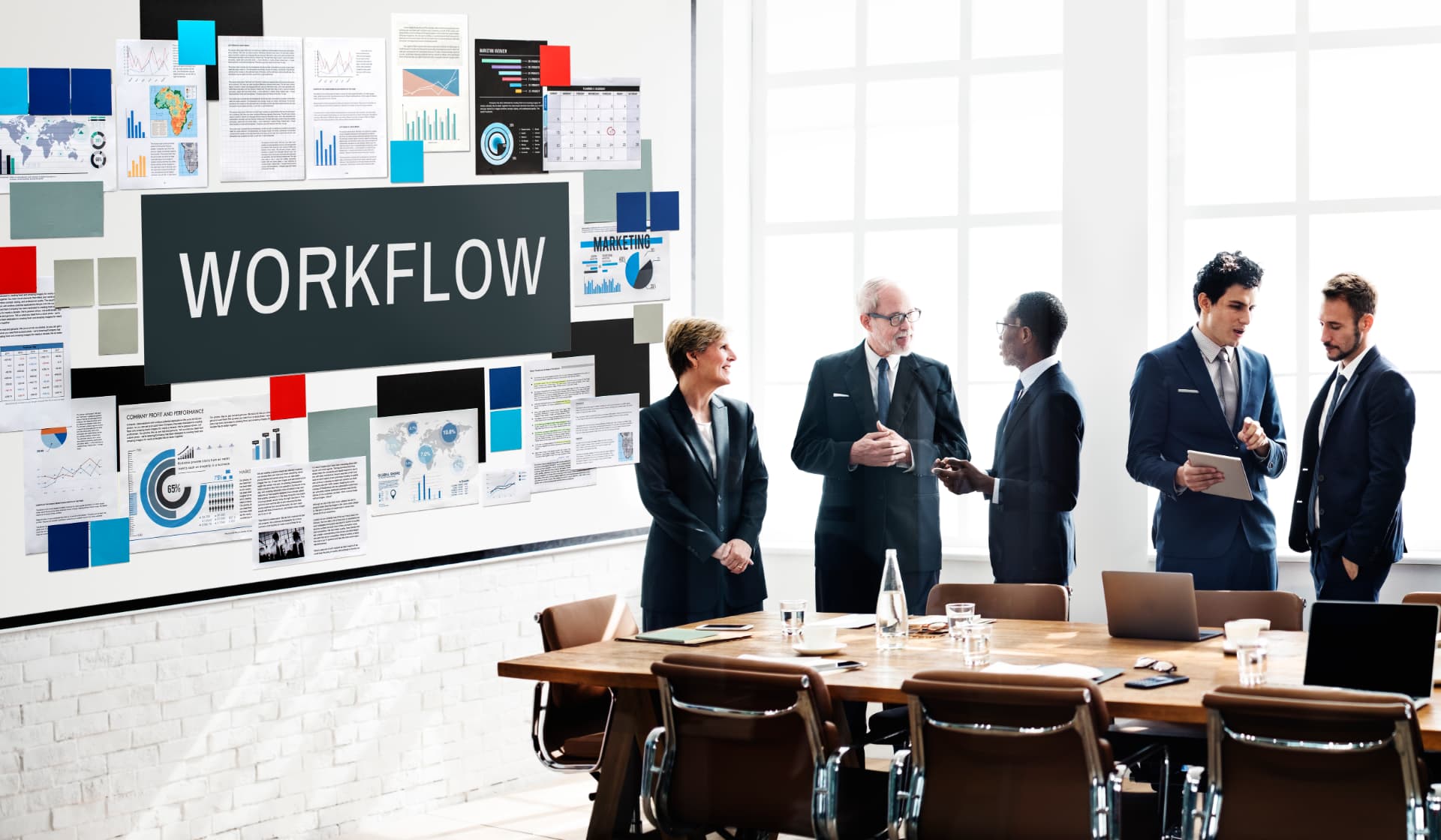 Team mapping a workflow on a wall of documents